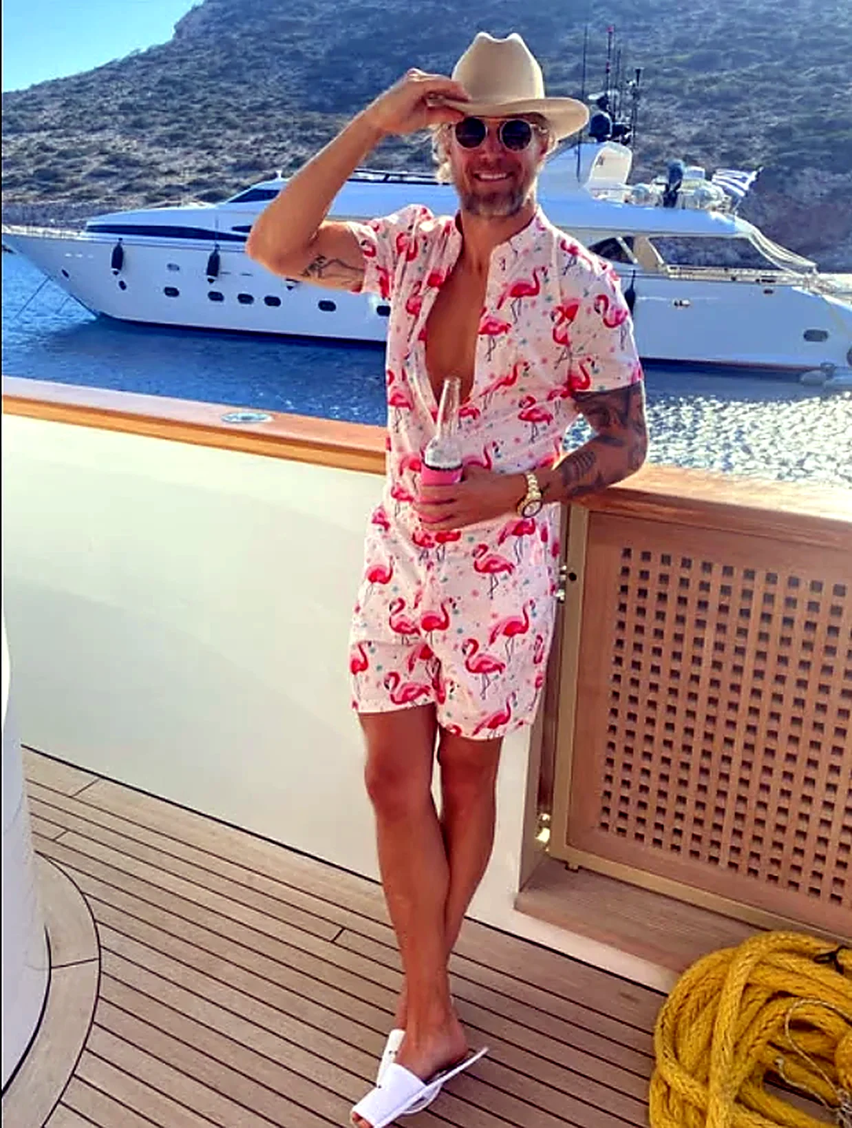 Andrew Welker on the deck of a yacht in a Mediterranean bay
